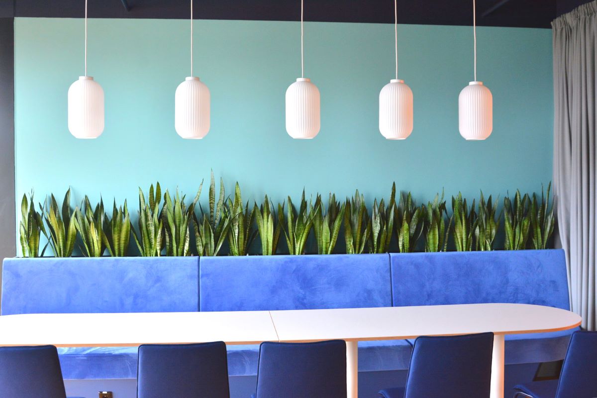 Moderní jídelna ve firmě s nábytkem osazeným rostlinami